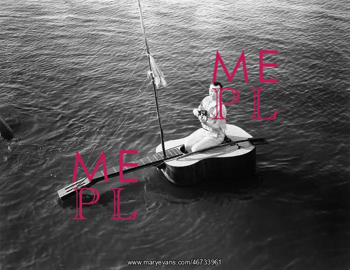 : Man sitting on a guitar sailboat : Man sitting on a guitar sailboat