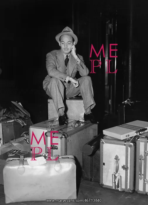 : Man sitting with luggage : Man sitting with luggage