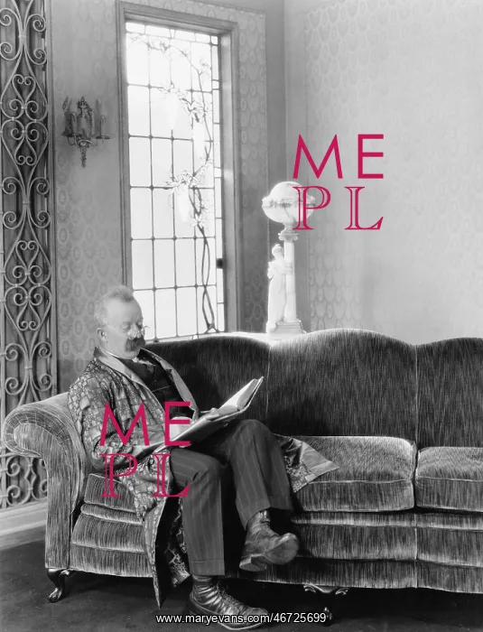  : Man sitting on sofa and reading a book