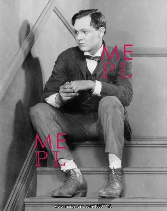 : Man sitting on stairs looking anxious : Man sitting on stairs looking anxious