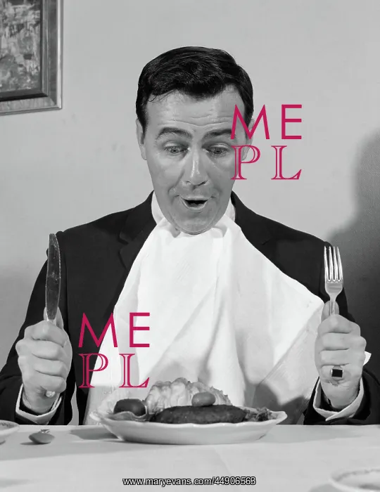 : Man sitting at table ready to eat dinner with : Man sitting at table ready to eat dinner with