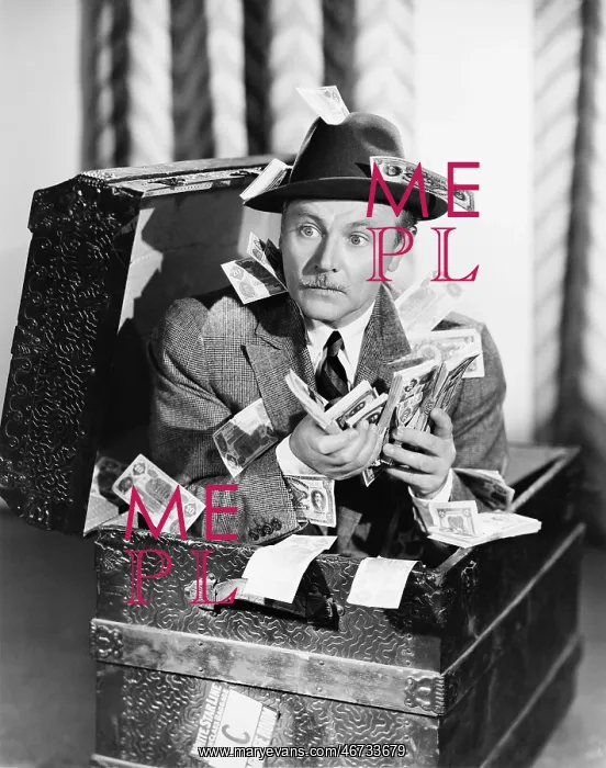 : Man sitting in a trunk with money in his hands : Man sitting in a trunk with money in his hands