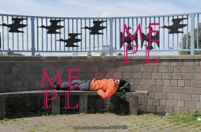 : A man sleeps on a bench on Morecambe promenade : A man sleeps on a bench on Morecambe promenade