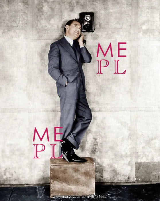 : Man standing on a box to reach the telephone : Man standing on a box to reach the telephone