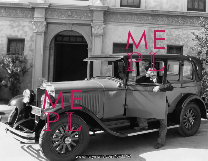 : Man standing next to his car : Man standing next to his car