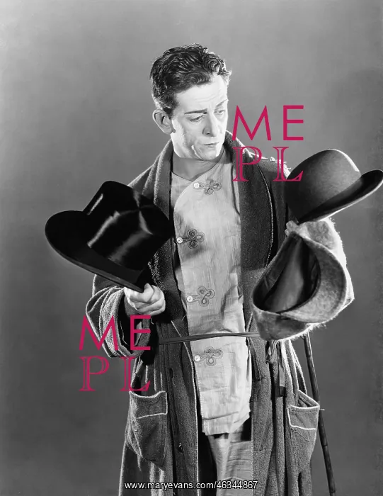 : Man standing and deciding between two hats : Man standing and deciding between two hats