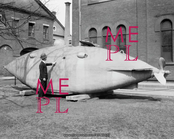 : Man Standing Next to Old Submarine from 1864 The : Man Standing Next to Old Submarine from 1864 The