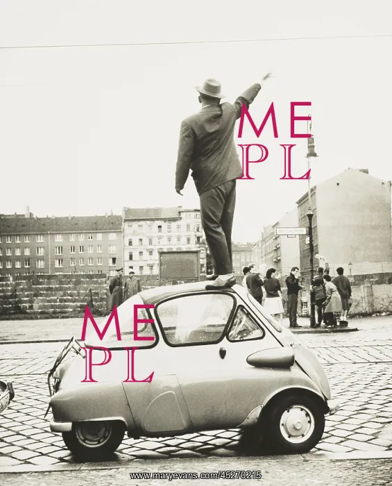 : A man standing on top of a small three-wheeled : A man standing on top of a small three-wheeled