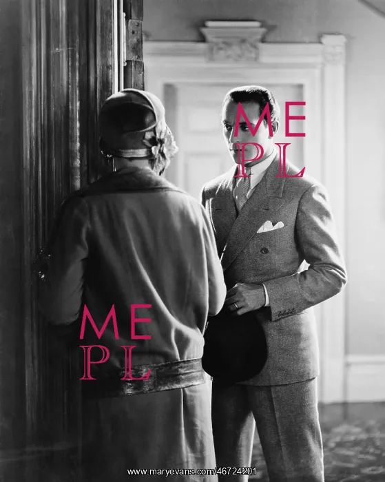 : Man standing in front of a woman at the doorway : Man standing in front of a woman at the doorway