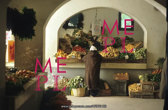 : Man stands at a fruit and vegetable stall in Djerba, Tunisia : Man stands at a fruit and vegetable stall in Djerba, Tunisia