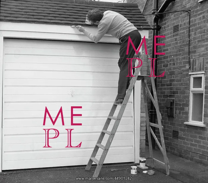 : Man up a step ladder, painting his garage : Man up a step ladder, painting his garage