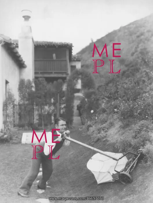 : Man struggling to mow lawn : Man struggling to mow lawn