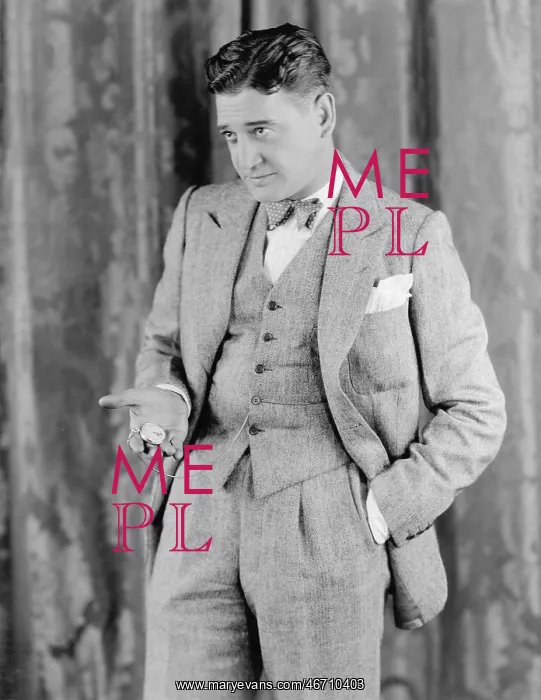 : Man in a suit holding his pocket watch : Man in a suit holding his pocket watch