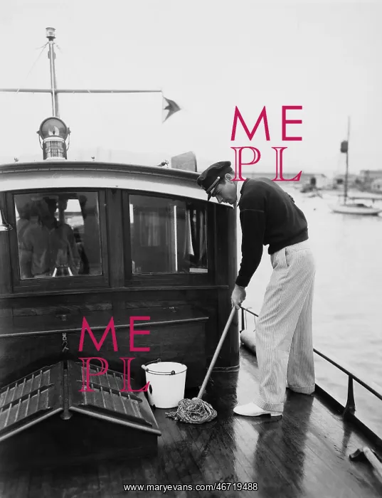 : Man swabbing deck of boat : Man swabbing deck of boat