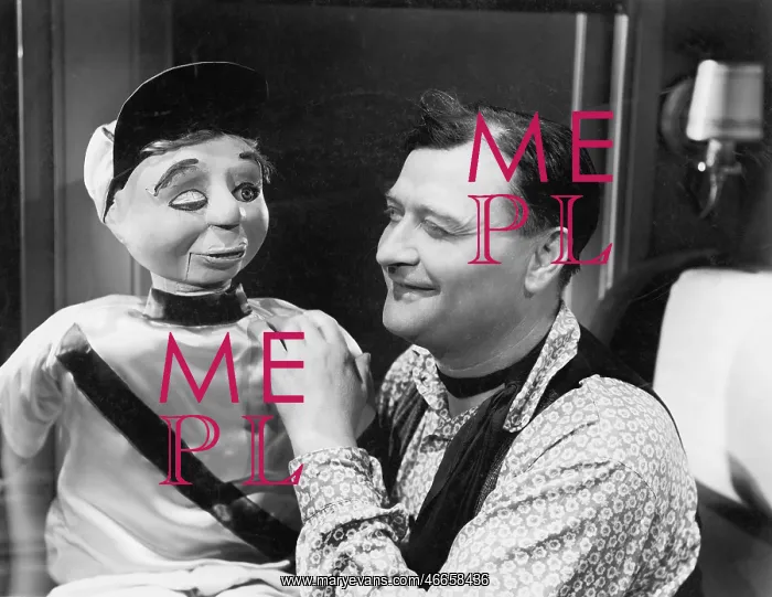 : Man talking and looking with his puppet : Man talking and looking with his puppet