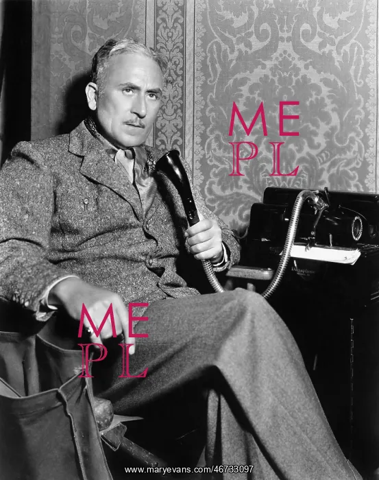 : Man talking on an old fashioned telephone : Man talking on an old fashioned telephone
