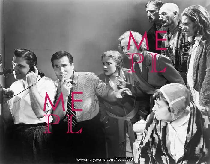 : Man talking on the telephone and his friends looking : Man talking on the telephone and his friends looking