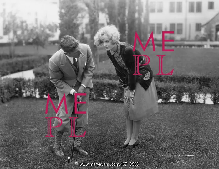 : Man talking to woman while golfing : Man talking to woman while golfing