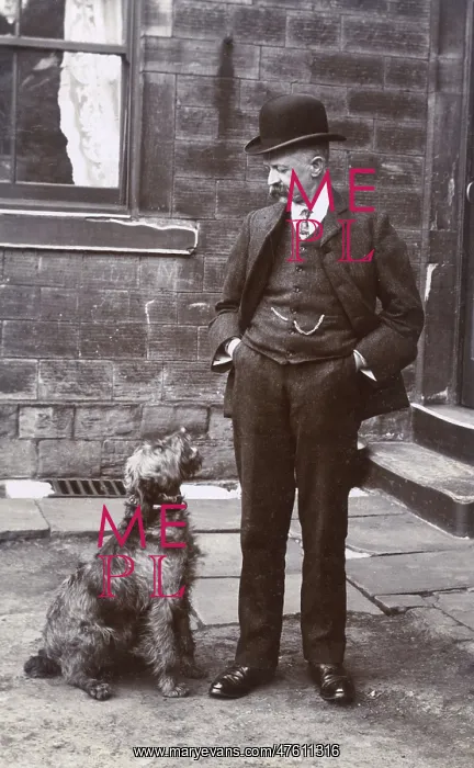  : Man with terrier dog outside a building