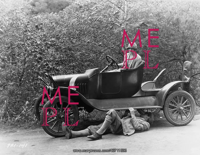  : Man trying to fix a broken down car