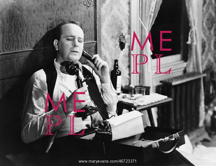 : Man with typewriter talking on phone : Man with typewriter talking on phone