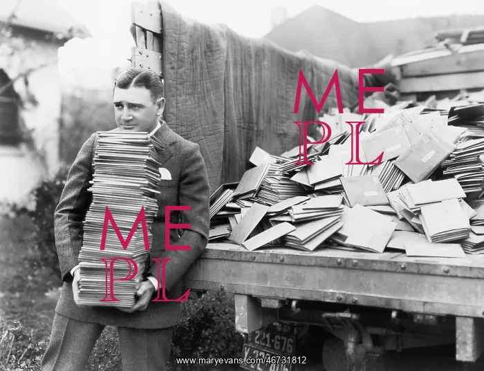 : Man unloading a truck full of letters : Man unloading a truck full of letters