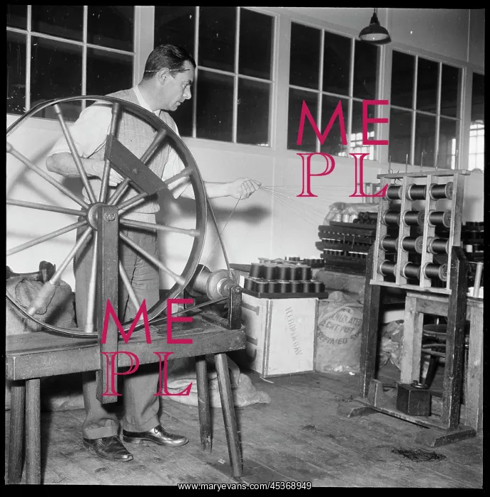 : A man using a hand operated silk doubling wheel : A man using a hand operated silk doubling wheel