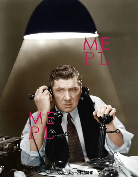 : Man using two telephones : Man using two telephones