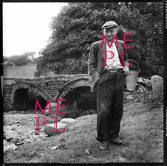 : Man, wearing traditional clogs, Packhorse Bridge at Wycoller : Man, wearing traditional clogs, Packhorse Bridge at Wycoller