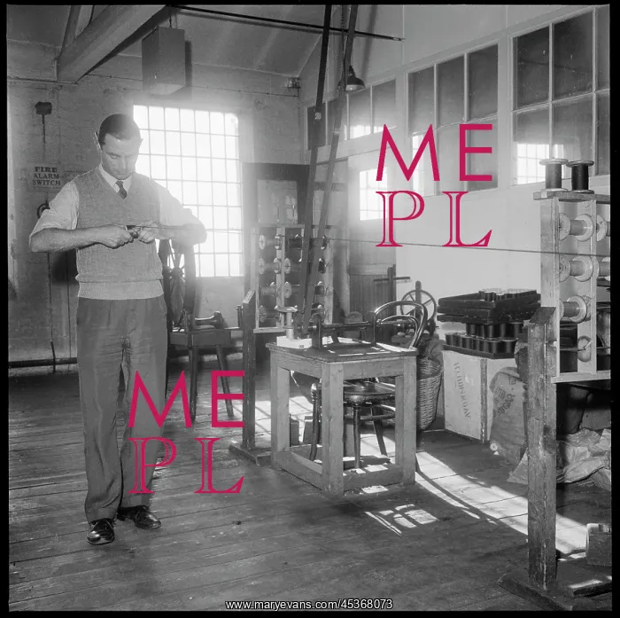 : A man winding a reel of silk by hand : A man winding a reel of silk by hand