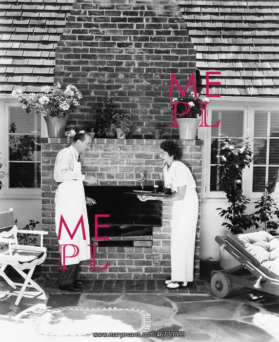 : Man in woman at their barbecue in the back yard : Man in woman at their barbecue in the back yard