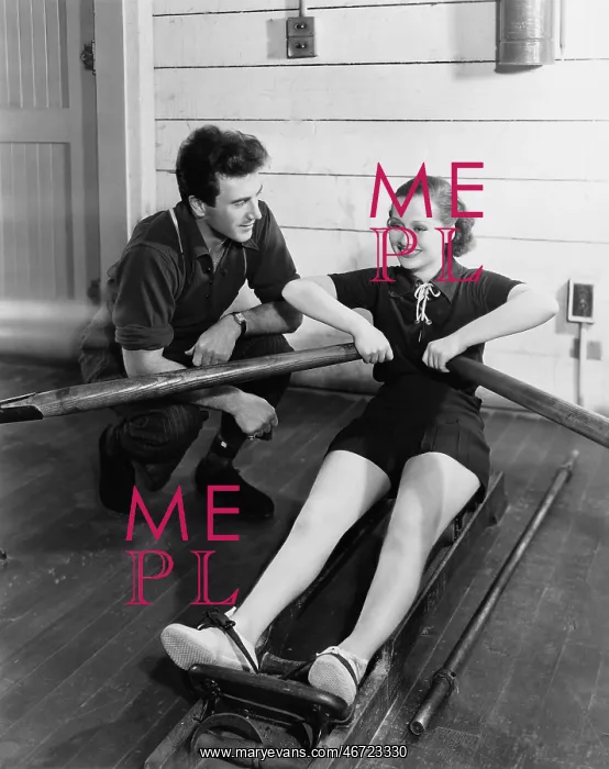 : Man with woman using rowing machine : Man with woman using rowing machine