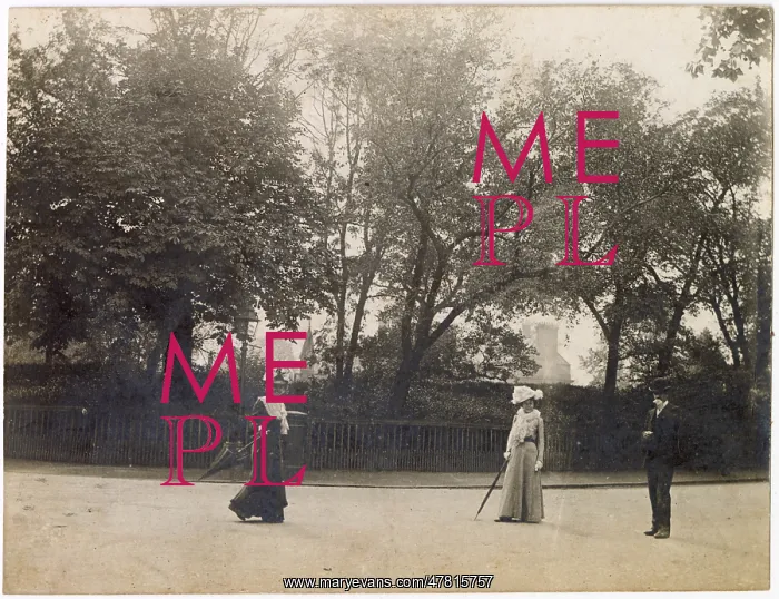 : Man and two women in the middle of a road : Man and two women in the middle of a road