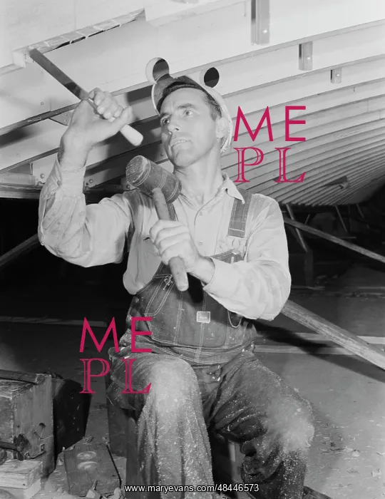 : Man working with a chisel on a beam of a motor : Man working with a chisel on a beam of a motor