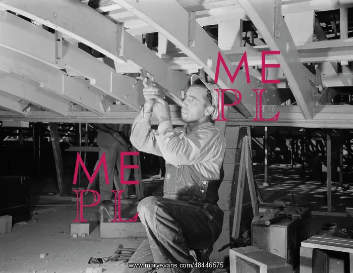: Man working with a chisel on a beam of a motor : Man working with a chisel on a beam of a motor