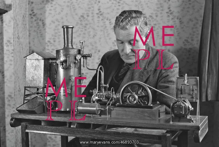 : Man working on miniature steam engine : Man working on miniature steam engine