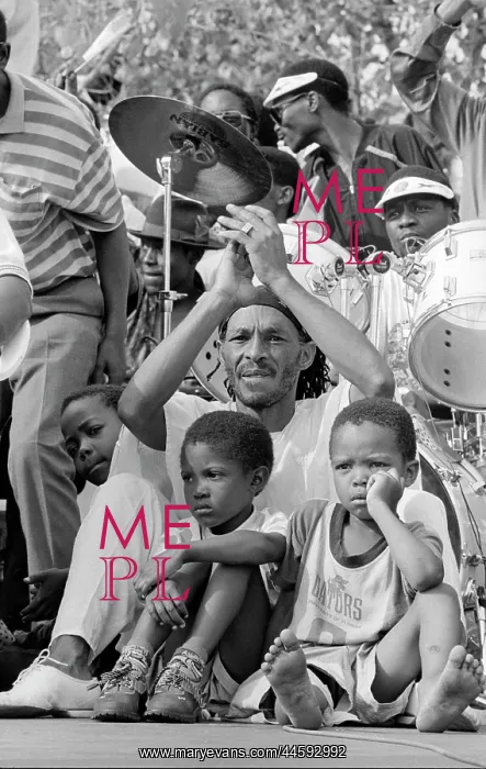 : A man with two young children sit in front of : A man with two young children sit in front of