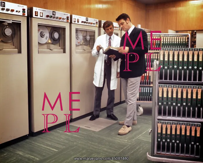  : Manager and Technician Standing Together Checking a Manual