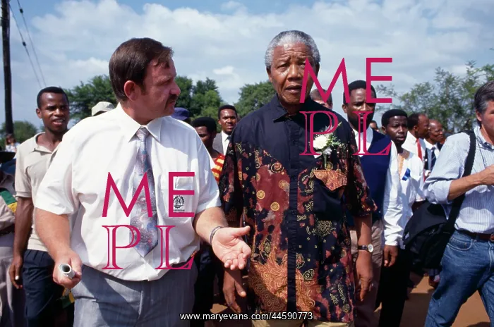 : Mandela on an election tour, wearing one of his : Mandela on an election tour, wearing one of his