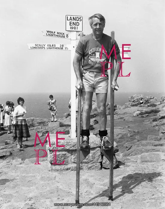 : Marathon stilt walker at Land's End, Cornwall : Marathon stilt walker at Land's End, Cornwall