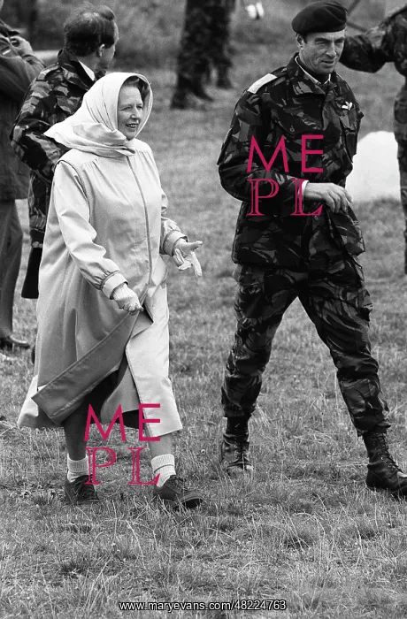 : Margaret Thatcher walking with a soldier : Margaret Thatcher walking with a soldier