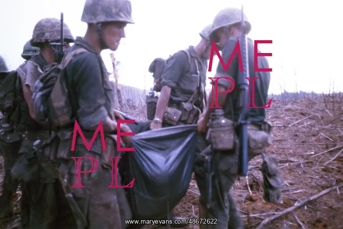 : Marines carry a dead comrade in a poncho at the : Marines carry a dead comrade in a poncho at the