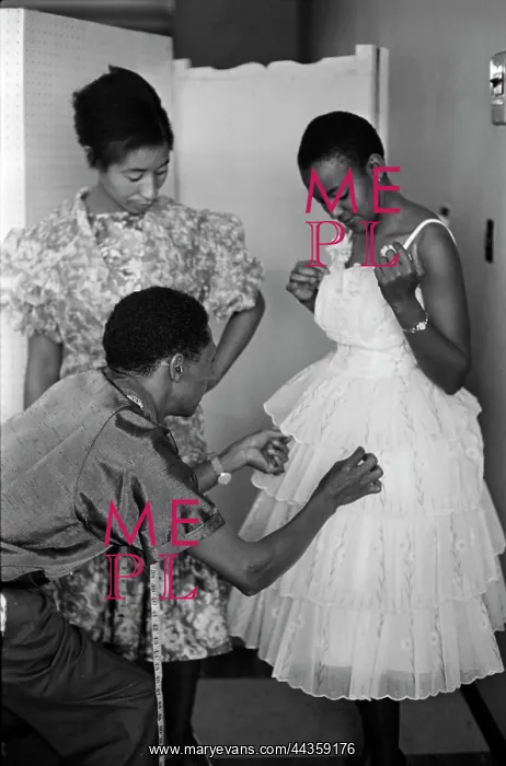 : May 1963 - Model Mojaki looks on as Molefe fiddles : May 1963 - Model Mojaki looks on as Molefe fiddles