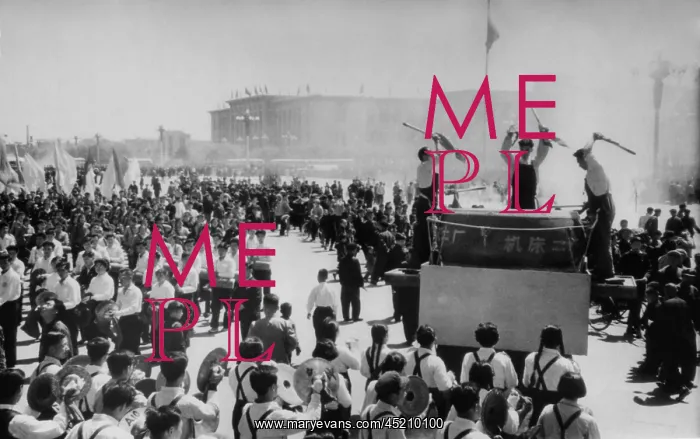 : May Day in Beijing. People parade past a ? : May Day in Beijing. People parade past a ?