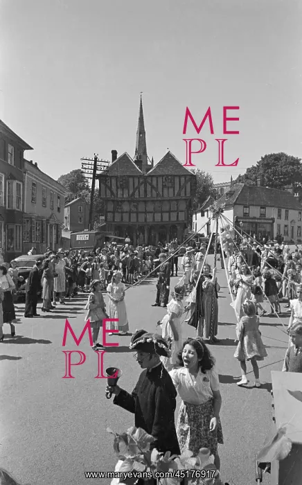 : May Pole. Spectators watching girls dancing around a May pole in front of the Guild Hall : May Pole. Spectators watching girls dancing around a May pole in front of the Guild Hall