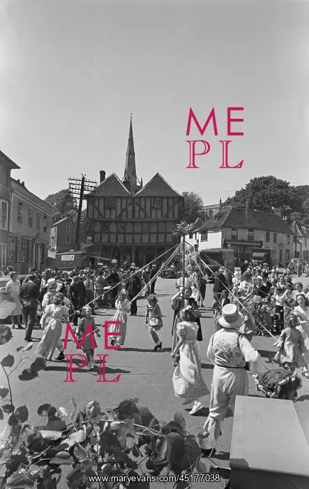 : May Pole. Spectators watching girls dancing around a May pole in front of the Guild Hall : May Pole. Spectators watching girls dancing around a May pole in front of the Guild Hall