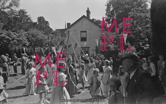 : May Pole. Girls dancing around a May pole at a garden party in Thaxted : May Pole. Girls dancing around a May pole at a garden party in Thaxted