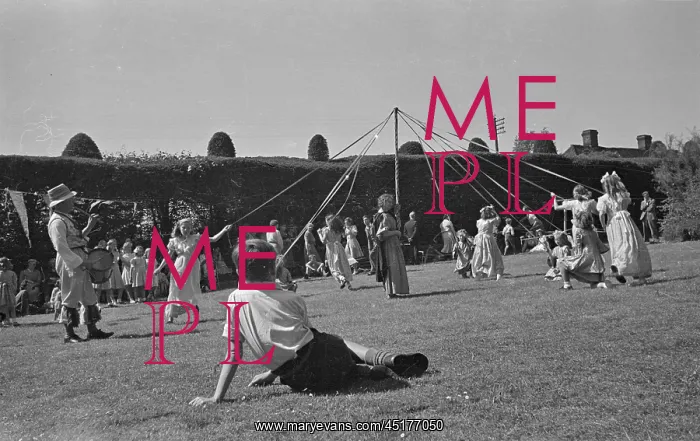 : May Pole. Children dancing around a May pole at a garden party in Thaxted : May Pole. Children dancing around a May pole at a garden party in Thaxted