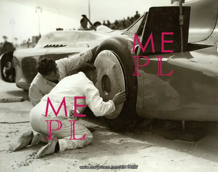 : Mechanics fitting hubcaps to Blue Bird : Mechanics fitting hubcaps to Blue Bird