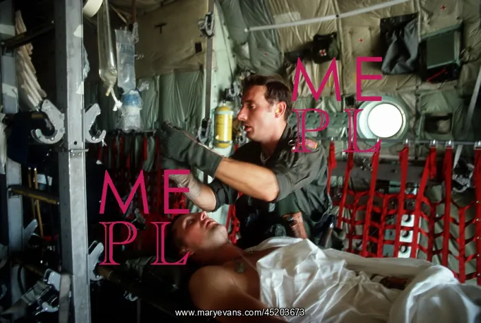 : A medic adjusts the intravenous drip bag ? : A medic adjusts the intravenous drip bag ?